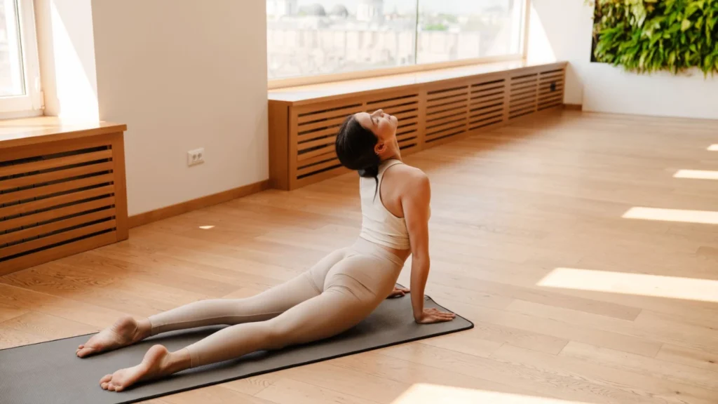 A lady performs a Somatic Pilates moves