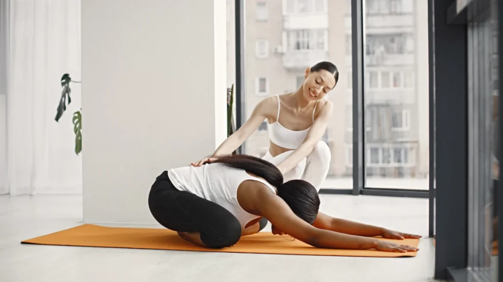 A lady guide the student for Somatic Pilates moves
