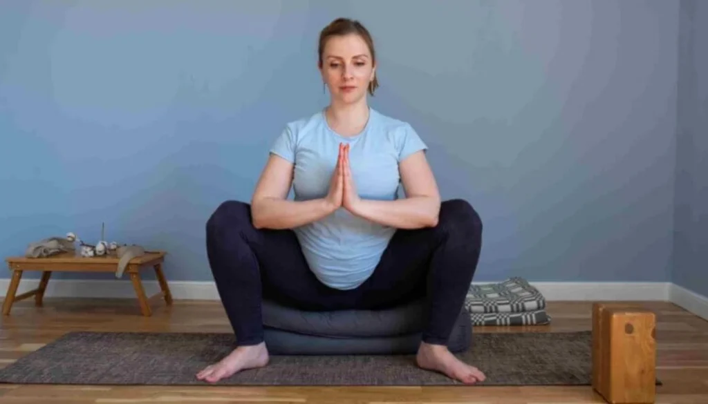 A lady performs a Malasana (Deep Squat)