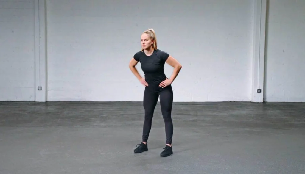 a lady stands and performs a hip circle